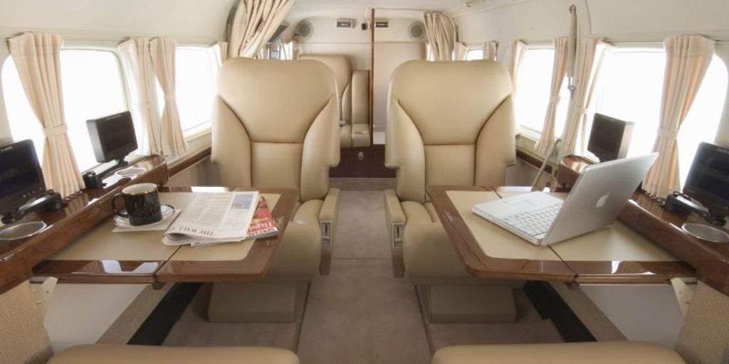 private jet interior with Wi-Fi and entertainment screens