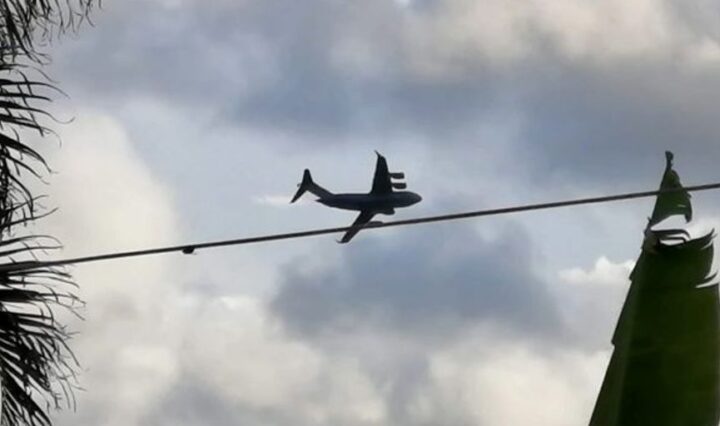 private jet flying over remote tropical island